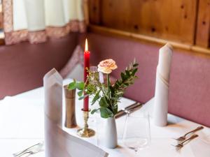 厄尔布鲁奎拉酒店的一张桌子,上面有两根蜡烛和一个花瓶