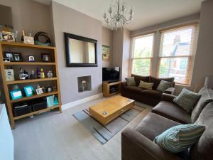 伦敦3 bed Apartment in Colliers Wood的带沙发和咖啡桌的客厅