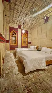 马斯喀特Fort Guesthouse نُزل القلعة的大房间,设有两张大床