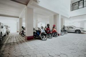 玛琅布吉特迪恩德帕拉贡旅馆的停在停车场的一排摩托车