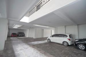 Alastuwo迪普瑞格凯杰优特旅馆的一辆白色的汽车停在一个车库里,有两辆车