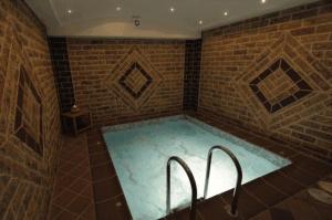 欧拉努波利斯Panorama Spa Hotel的砖墙客房内的浴缸