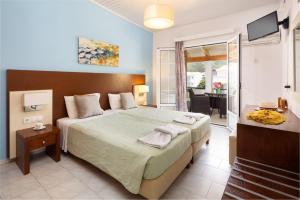 阿齐欧斯·贡多斯丹帝迪斯海边旅馆的一间带大床的卧室和一个阳台
