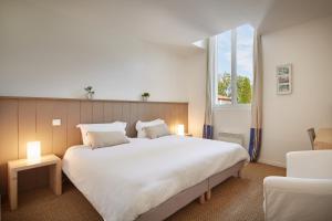 梅桑热Hotel La Maison de la Prade的卧室设有一张白色大床和一扇窗户。
