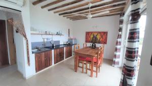 吉汶瓦Maisha Marefu Apartments的厨房配有木桌和水槽。