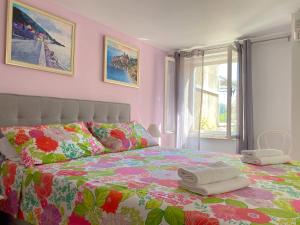 波尔梅里旅馆的一间卧室配有一张带五颜六色棉被的床