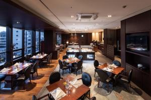 首尔首尔世贸中心奥卓豪景酒店公寓的餐厅设有木桌、椅子和柜台