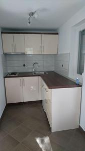 索科矿泉村NEW Novi Apartment Mirjana的厨房配有白色橱柜和水槽