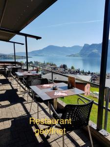 赫尔吉斯维尔罗格里酒店的一间带桌椅并享有水景的餐厅