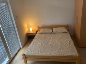 大格拉迪什泰Vila ViV Srebrno Jezero的一间小卧室,配有一张床和一个带蜡烛的床头柜