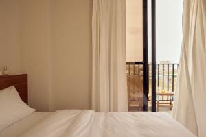 马公日光事务所的一间卧室设有一张床,享有阳台的景色