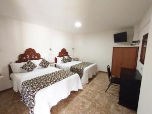 Hotel Royal Puebla客房内的一张或多张床位