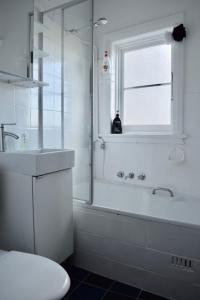 悉尼Cosy 3 Bedroom Apartment In Trendy Haberfield的带淋浴、浴缸和盥洗盆的浴室