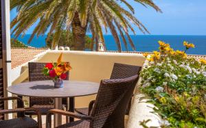 卡武埃鲁阿尔加塞科公园公寓式酒店的海景露台上的桌椅