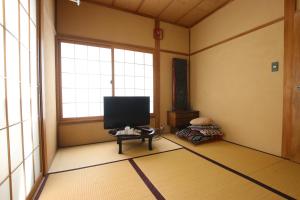 东京May Guest House的带窗户的客房内配有平面电视。