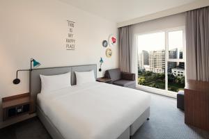 迪拜Rove City Centre, Deira的卧室设有白色的床和大窗户