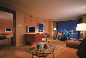 香港九龙香格里拉的酒店客房带起居室,带一张床和一张沙发。