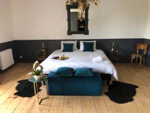 DamvixLa Belle Epoque - Chambres d'hôtes & SPA的一间卧室配有一张大床和蓝色的沙发
