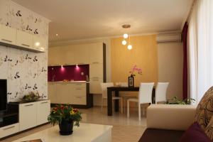 比亚拉Vello Apartments的厨房以及带桌椅的起居室。