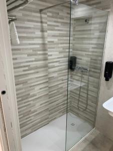莫特里尔海星酒店的浴室里设有玻璃门淋浴