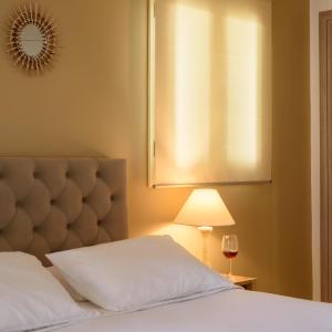 费拉圣托里尼之家别墅的一间卧室配有一张带灯和窗户的床