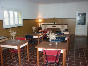门多萨马洛卡酒店的用餐室配有木桌和红色椅子