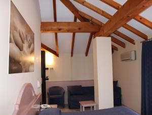 马斯诺维斯康蒂罗思澄堂勒酒店的客厅设有蓝色的沙发和木制天花板。