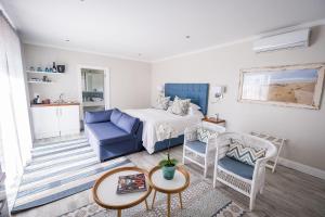 伊丽莎白港阿德美拉尔提海滨别墅酒店的一间卧室配有一张床、一张沙发和一张桌子