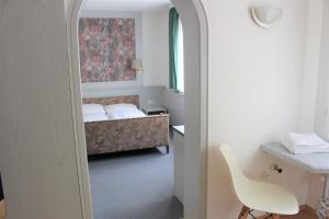 乌尔姆乌尔姆文雀酒店的客房设有一张床、一张桌子和一把椅子。