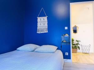 奥尔良Au Canon - Parking gratuit - Bords de Loire的蓝色的卧室,配有一张蓝色墙壁的床