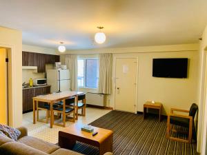 米西索加Green Acres Motel的带沙发和桌子的客厅以及厨房。