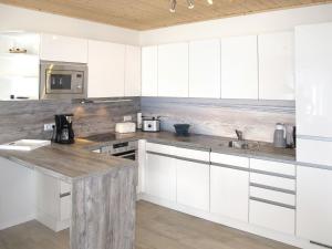 阿尔特费尔Holiday Home Sanddorn by Interhome的厨房配有白色橱柜和台面
