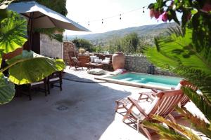 BenialiCa la Pasita 26的一个带椅子的庭院和一个游泳池
