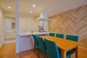 宫古岛Ecot Irabu Bridge Premier的厨房配有木桌和蓝色椅子