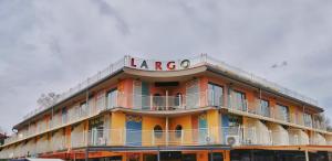阳光海滩Hotel Largo Beach的一座大型橙色建筑,上面有大标志