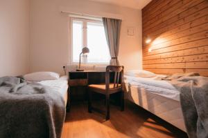 基尔匹斯扎我维基尔皮斯拉普兰酒店的一间卧室设有两张床、一张桌子和一个窗口。