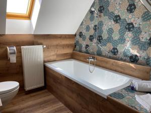 巴拉顿菲赖德Harmonia Apartman erkéllyel és SZAUNAval的带浴缸和卫生间的浴室。