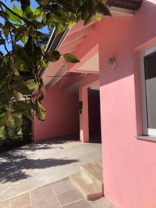 格拉玛多Pousada Beija Flor Centro的窗户房子的粉红色墙