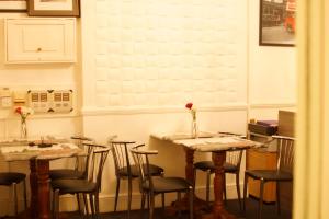 伦敦广场酒店的用餐室配有桌椅和鲜花