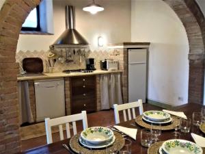 圣焦万尼达索La Capanna,piscina,vista,WiFi,in paese的厨房以及带桌椅的用餐室。