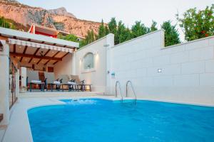 马卡尔斯卡Idyllic villa Marieta with private pool and unforgettable view的一个带庭院和房子的游泳池