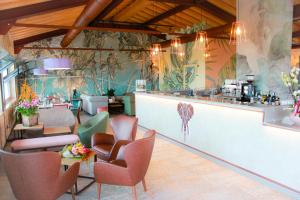 马内尔巴桑希维诺公寓酒店的餐厅设有酒吧,配有桌椅