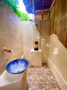 Ban RaiBan Rai Jai Chaem - Spa Cafe & Homestay的浴室配有蓝色水槽和浴缸。