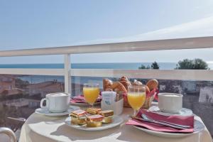 塔拉戈纳圣霍尔迪酒店的一张桌子,上面有早餐食品和两杯橙汁