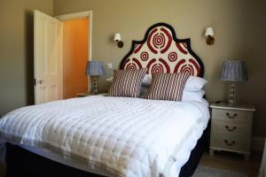 Bishops CanningsCockloft Romantic Countryside Hideaway的一间卧室配有一张大床,设有红色和白色的床头板