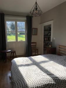 韦尔南图瓦Golf Val de Sorne Vernantois Maison vigneronne的一间卧室设有一张床和一个大窗户