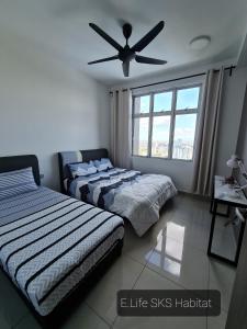 新山E Life SKS Habitat With WiFi Netflix的一间卧室配有两张床和吊扇