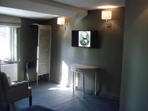 罗什福尔拉斐特酒店的一间黑暗的房间,墙上挂着一张凳子和一张照片