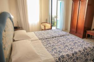 索伦托拉巴​​迪亚酒店的一间卧室配有一张带蓝色和白色被子的床