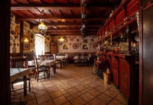 班斯卡-比斯特里察库利亚酒店的一间带桌椅的餐厅和一间酒吧
